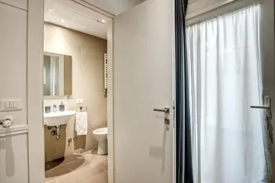 a bathroom with a toilet and a sink at Colosseo Suite Apartment in Rome