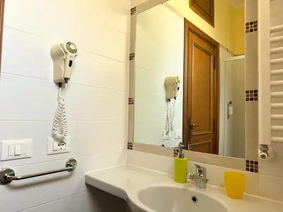 a bathroom with a sink and a phone on the wall at Anthony House, Anthony Floor 3, Castro Pretorio in Rome