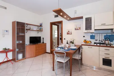 a kitchen with a table and chairs in a room at Residenza il Parco 3 in Rome