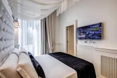 a bedroom with a bed and a large window at Hotel dei Quiriti Suite in Rome