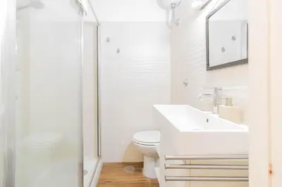 a white bathroom with a sink and a toilet at Tevere apartments in Rome