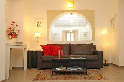 a living room with a brown couch and a table at Great Central Apartment in Rome