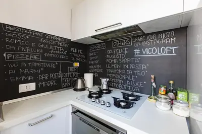 a kitchen with a blackboard on the wall at Vicoloft Vicolo in Rome