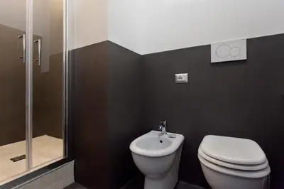 a bathroom with a toilet and a shower at Secret Rhome in Rome