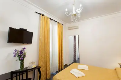 a room with a table and a tv on the wall at Secret Rhome in Rome