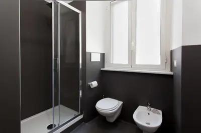 a bathroom with a toilet and a shower and a sink at Secret Rhome in Rome