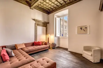 a living room with a couch and a chair at Piazza Farnese exclusive view 2 bedroom en suite in Rome