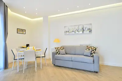 a living room with a couch and a table at New Romantic Trastevere Apartment in Rome