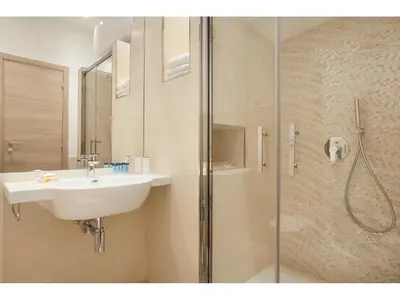 a bathroom with a sink and a shower at Jackie's Apartments in Rome