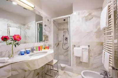 a bathroom with a sink and a shower at UNA Hotels Empire Roma in Rome