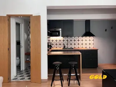 a kitchen with a counter and stools in it at Albornoz 35 in Rome