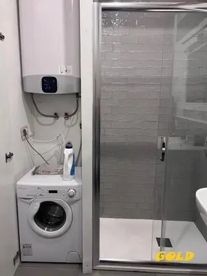 a bathroom with a washing machine and a shower at Albornoz 35 in Rome