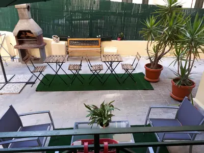a patio with a bench and chairs and plants at Clodio Rooms in Rome