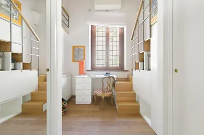 a hallway with a desk and a window at Leopardo 28 - Loft in Trastevere in Rome