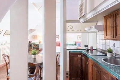 a bedroom with a bed and a chair and cabinets at Piazza Colonna Apartment - Charme Holidays in Rome