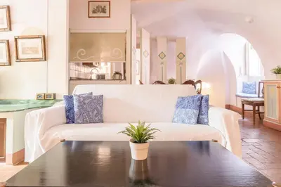 a room with a table with a painting on the floor at Piazza Colonna Apartment - Charme Holidays in Rome