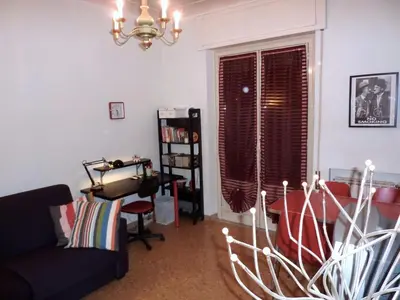 a living room with a couch and a chair at Tommy Guest House Roma in Rome