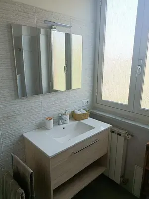 a bathroom with a white sink and a mirror at Tommy Guest House Roma in Rome
