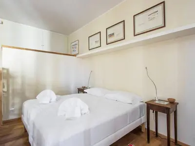 a bedroom with a white bed with two pillows at Al Portico 39 Apartment in Rome