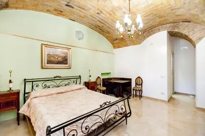 a bedroom with a bed and a table and chairs at Stop Colosseo in Rome