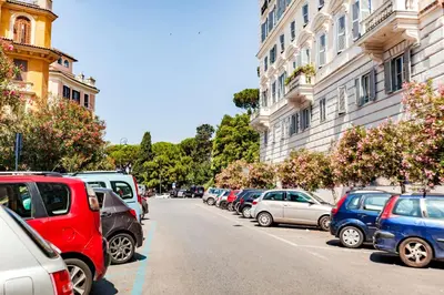 a row of cars parked on the side of a street at Stop Colosseo in Rome
