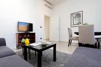 a living room with a couch and a tv and a table at Piazza Capponi Apartment in Rome