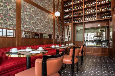 a restaurant with tables and chairs and a red couch at Hotel Damaso in Rome