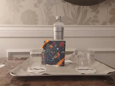 a bottle of water and two glasses on a tray at Hotel Damaso in Rome