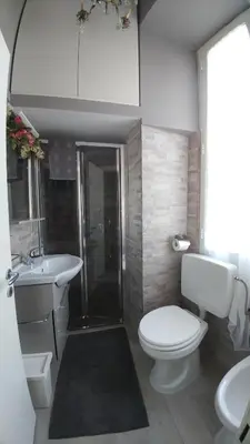 a bathroom with a toilet and a sink and a shower at Luca's Vatican Hospitality in Rome