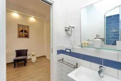 a bathroom with a sink and a mirror at La Finestra sul Vaticano in Rome