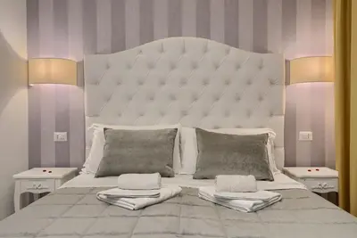 a bedroom with a large white bed with two pillows at Relais Vatican Secret in Rome