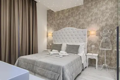 a bedroom with a large bed with a large headboard at Relais Vatican Secret in Rome