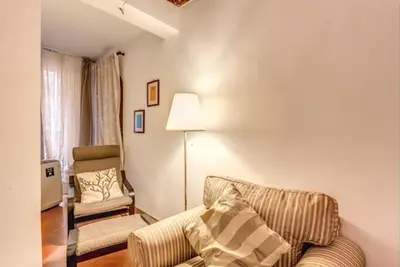 a living room with a couch and a chair at Navona Flat di Elena & Paola in Rome