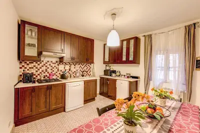 a kitchen with a table with a bowl of fruit on it at Navona Flat di Elena & Paola in Rome