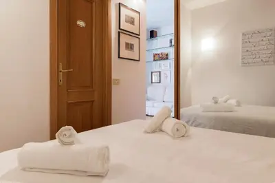 a room with two towels on a bed with a mirror at Lago Terrione Apartment - Charme Holidays in Rome