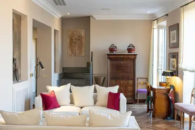a living room with a white couch and red pillows at Rental in Rome - Fontana Di Trevi Penthouse in Rome