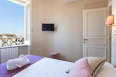 a bedroom with a bed and a window at Rental in Rome - Fontana Di Trevi Penthouse in Rome