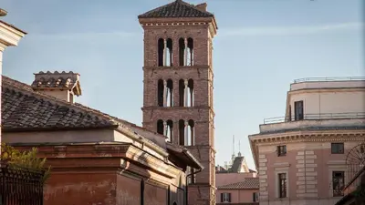 a tall building with a clock tower in a city at Rental in Rome - Gambero Suite in Rome