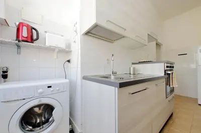 a kitchen with a washing machine and a sink at Casa Rossi Roma in Rome