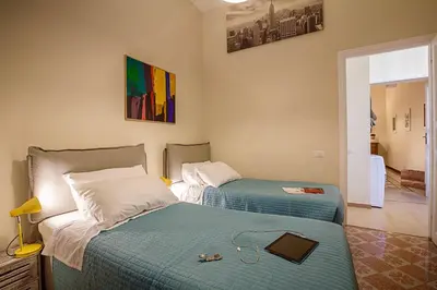 two beds in a room with a room with at RomaAmor in Rome
