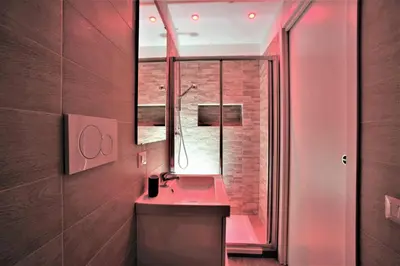 a bathroom with a pink sink and a mirror at RomaAmor in Rome