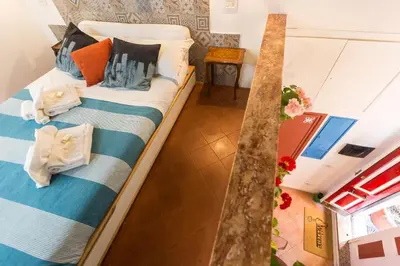 a living room with a table and a clock on the wall at Moroni Trastevere Cozy Apartment in Rome