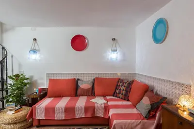 a living room with a couch and a bed at Moroni Trastevere Cozy Apartment in Rome