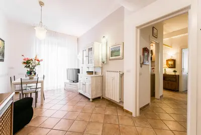 a living room with a kitchen and a dining room at Maison Velia San Giovanni in Rome