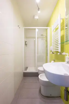 a bathroom with a toilet and a sink and a shower at St Peter Rooms in Rome