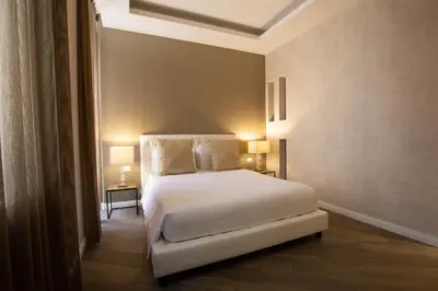 a bedroom with a white bed and two lamps at Spagna Boutique in Rome