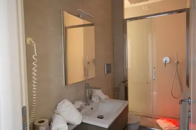 a bathroom with a sink and a shower at Spagna Boutique in Rome