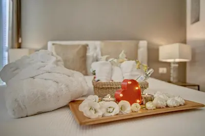 a bed with a tray of towels and a tray of towelshiba at Spagna Boutique in Rome