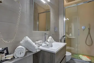 a bathroom with a sink and a shower and a toilet at Spagna Boutique in Rome