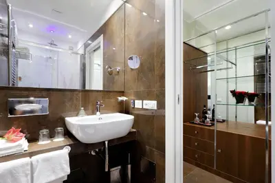 a bathroom with a sink and a glass shower at Piazza Venezia Grand Suite in Rome